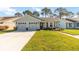 Charming single-story home with attached two-car garage and well-manicured lawn at 9559 Dubois Blvd, Orlando, FL 32825