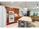 Bright kitchen featuring white appliances, wood cabinets, and an island with seating space at 9559 Dubois Blvd, Orlando, FL 32825