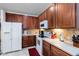 Well-equipped kitchen with wood cabinets, modern appliances, and ample counter space at 9559 Dubois Blvd, Orlando, FL 32825