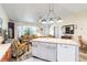 Open floor plan features a living room and kitchen with an island and modern lighting at 9559 Dubois Blvd, Orlando, FL 32825