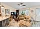 Comfortable living room showcasing wood floors, a large TV, and ample natural light at 9559 Dubois Blvd, Orlando, FL 32825
