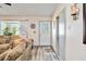 Cozy living room featuring wood floors, large windows, and a decorative glass door at 9559 Dubois Blvd, Orlando, FL 32825