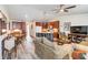 Open-concept living space with wood floors, a kitchen island, and comfortable seating at 9559 Dubois Blvd, Orlando, FL 32825