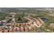 An aerial view featuring terra cotta homes, tranquil ponds and wooded vistas in a beautiful community at 113 Tiger Lily Ct, Davenport, FL 33837