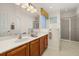 Large bathroom featuring a double sink vanity, large mirror and a tiled walk-in shower at 113 Tiger Lily Ct, Davenport, FL 33837