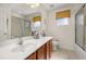 Bathroom with a spacious countertop, sink, toilet, and a bathtub/shower with glass door at 113 Tiger Lily Ct, Davenport, FL 33837