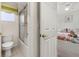 Well-maintained bathroom with a shower-tub combo, toilet, and door leading to a stylish bedroom at 113 Tiger Lily Ct, Davenport, FL 33837