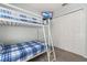A cozy bedroom with a bunk bed and a TV mounted on the wall at 113 Tiger Lily Ct, Davenport, FL 33837