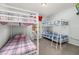 bedroom featuring two sets of bunk beds, window, and light blue walls at 113 Tiger Lily Ct, Davenport, FL 33837