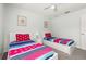 Bedroom with two twin beds and small side tables with lamps and colorful bedding at 113 Tiger Lily Ct, Davenport, FL 33837