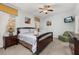 Comfortable bedroom boasts a queen bed, ceiling fan, and relaxing decor at 113 Tiger Lily Ct, Davenport, FL 33837