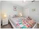 Bright bedroom with a decorative bed, fresh linens, coordinated nightstands, and ample natural light at 113 Tiger Lily Ct, Davenport, FL 33837