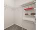 Walk-in closet with white wire shelving and carpeted floor offers ample storage space at 113 Tiger Lily Ct, Davenport, FL 33837