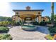 The Watersong clubhouse featuring a central fountain, clock tower, and manicured landscaping at 113 Tiger Lily Ct, Davenport, FL 33837
