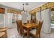 Sunlit dining area with seating for eight and scenic backyard views at 113 Tiger Lily Ct, Davenport, FL 33837