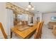 Bright dining room featuring a wooden table, six chairs, tile flooring, and natural light from the window at 113 Tiger Lily Ct, Davenport, FL 33837