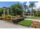 Watersong community entrance with a fountain, lush greenery, and well-maintained landscaping along a brick-paved road at 113 Tiger Lily Ct, Davenport, FL 33837