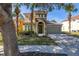 Charming two-story home with tile roof, arched entry, and well-manicured landscaping at 113 Tiger Lily Ct, Davenport, FL 33837
