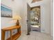 Bright foyer with tiled flooring and a view to the landscaped front yard at 113 Tiger Lily Ct, Davenport, FL 33837
