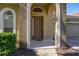 Inviting front entrance featuring an arched entryway and well-maintained landscaping at 113 Tiger Lily Ct, Davenport, FL 33837