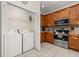 Efficient kitchen with stainless steel appliances and a washer/dryer closet at 113 Tiger Lily Ct, Davenport, FL 33837