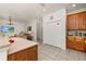 Open-concept kitchen with wood cabinets, tile backsplash, and stainless steel appliances at 113 Tiger Lily Ct, Davenport, FL 33837