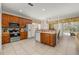 Bright kitchen with a center island, wood cabinets, and access to the backyard at 113 Tiger Lily Ct, Davenport, FL 33837