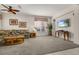 Spacious living room with neutral carpet, ample light, and a mounted television at 113 Tiger Lily Ct, Davenport, FL 33837