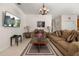Inviting living room with comfortable seating, warm lighting, and a seamless connection to the adjacent spaces at 113 Tiger Lily Ct, Davenport, FL 33837