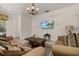 Inviting living room with neutral walls, comfortable sofas, and tile flooring at 113 Tiger Lily Ct, Davenport, FL 33837