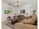 Comfortable living room with neutral walls, comfortable sofas, and tile flooring at 113 Tiger Lily Ct, Davenport, FL 33837