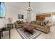 Cozy living room featuring tile flooring, neutral furniture, and an open layout at 113 Tiger Lily Ct, Davenport, FL 33837