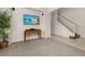 Inviting living room featuring a modern TV and a staircase to the upper level at 113 Tiger Lily Ct, Davenport, FL 33837