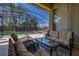 Outdoor patio area with comfortable seating around a glass-topped table and pool with a safety fence at 113 Tiger Lily Ct, Davenport, FL 33837