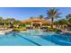 Resort-style pool with ample seating and lush landscaping; perfect for relaxation and recreation at 113 Tiger Lily Ct, Davenport, FL 33837