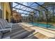 Inviting screened-in pool area with lounge chairs and ample space for relaxation at 113 Tiger Lily Ct, Davenport, FL 33837