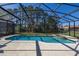 Serene screened-in pool and spa area offering a secluded oasis at 113 Tiger Lily Ct, Davenport, FL 33837