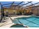 The sparkling screened-in pool provides a refreshing escape with views of the patio area at 113 Tiger Lily Ct, Davenport, FL 33837