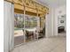 View of screened patio furniture set, pool, and bedroom with ceiling fan and art through sliding glass doors at 113 Tiger Lily Ct, Davenport, FL 33837