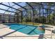 Inviting screened-in pool and spa offer a relaxing outdoor retreat with lush landscaping at 113 Tiger Lily Ct, Davenport, FL 33837