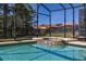 The sparkling screened-in pool provides a refreshing escape with views of the neighboring homes at 113 Tiger Lily Ct, Davenport, FL 33837