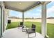 Back porch with outdoor furniture, string lights and a manicured backyard at 1185 Catskill Dr, Haines City, FL 33844