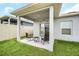 Covered back patio with string lights overlooking the backyard at 1185 Catskill Dr, Haines City, FL 33844