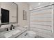 Well-appointed bathroom with marble vanity top, modern mirror, and decorative shower curtain at 1185 Catskill Dr, Haines City, FL 33844