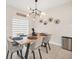 Contemporary dining room with modern chandelier, sleek table setting and light-colored tile flooring at 1185 Catskill Dr, Haines City, FL 33844