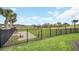 Fenced community dog park area with mature trees, and lush green grass at 1185 Catskill Dr, Haines City, FL 33844