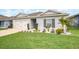 Single-story home boasts green lawn, landscaping, and a two-car garage, offering curb appeal at 1185 Catskill Dr, Haines City, FL 33844