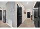 Bright hallway with decorative wall texture leads to the living spaces and stainless steel appliances at 1185 Catskill Dr, Haines City, FL 33844