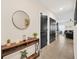 Hallway with modern console table and mirror offers a glimpse into the open-plan living area at 1185 Catskill Dr, Haines City, FL 33844