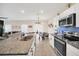 Bright, modern kitchen with stainless steel appliances and views to the dining and living areas at 1185 Catskill Dr, Haines City, FL 33844
